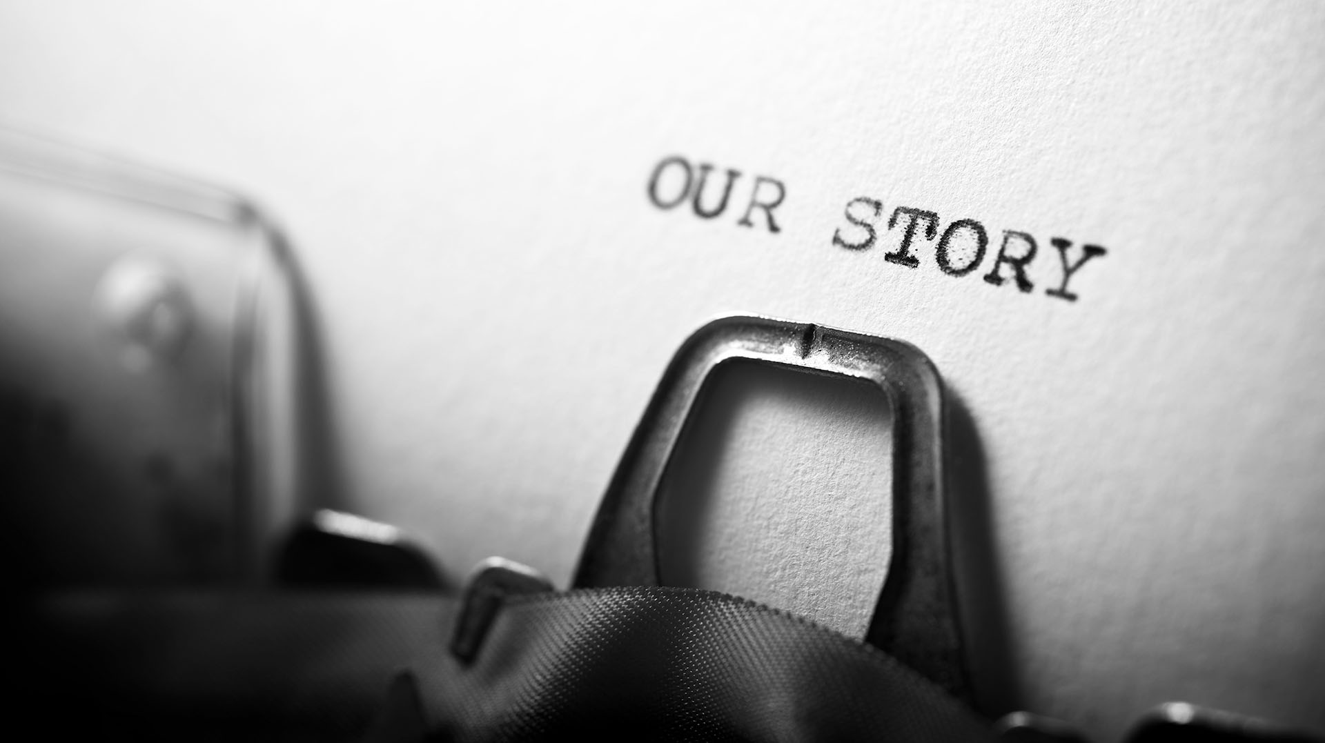Image showing a typewriter with "Our story" being typed